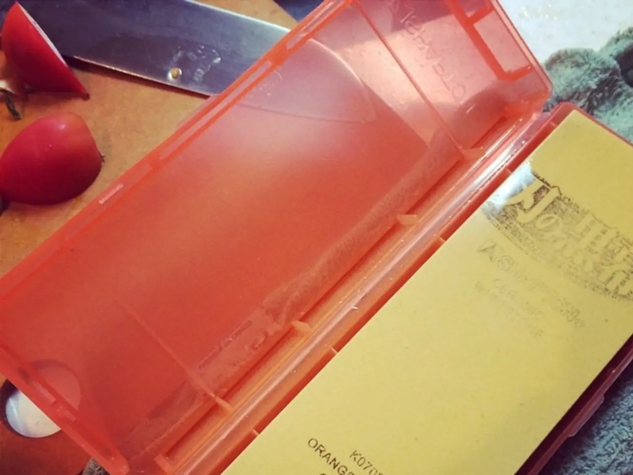 In this image there is a knife, box, cloth and a few other objects on the platform.