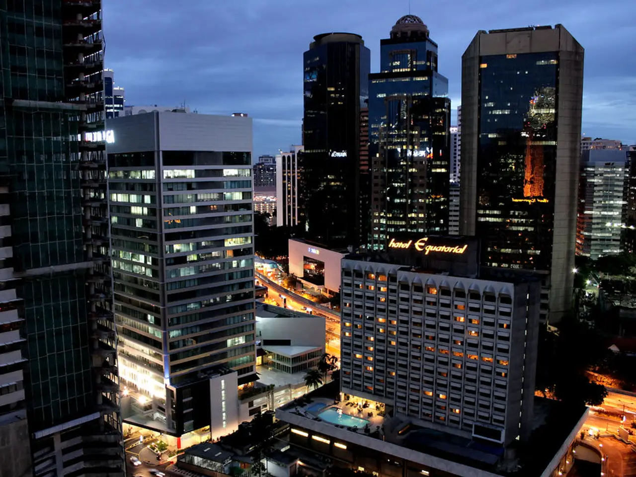 In this image I see number of buildings and I see a swimming pool over here and I see a board over...