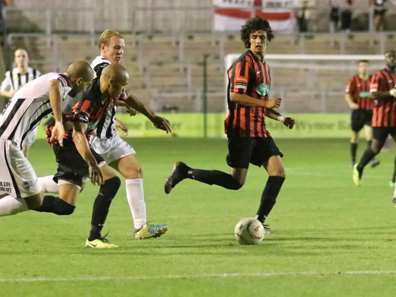 In this picture I can see a group of people are playing the football, in the background there are...