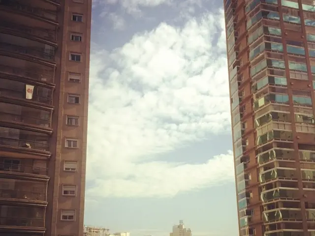 In the image there are buildings on either sides with many buildings in the background, this seems...