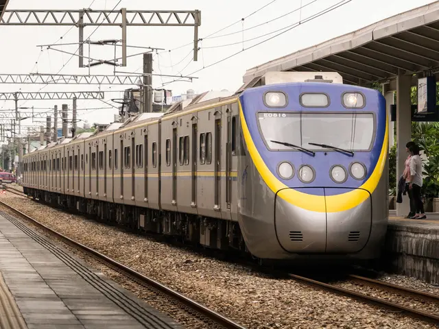 In the image there is a train on the track and beside the train few people were standing on the...