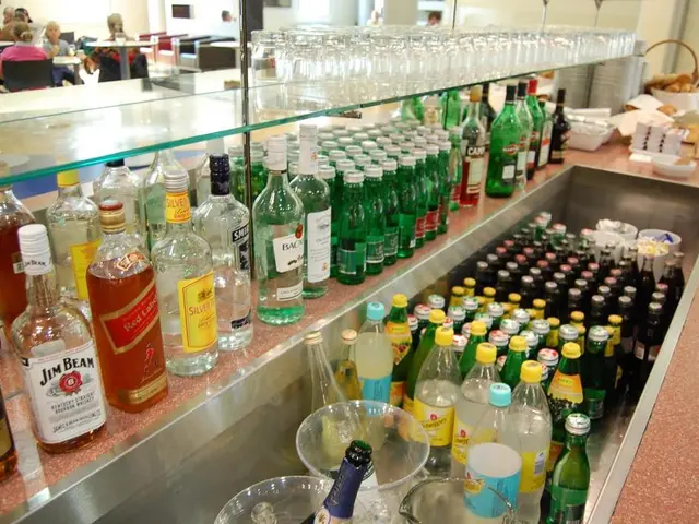This picture shows a bottles of different drinks arranged in a shelf and some are in the tray here....