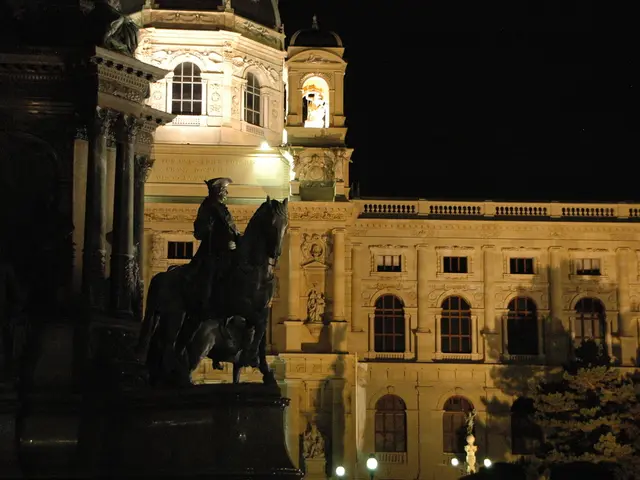 In the picture we can see a historical building and near to it we can see a sculpture of a man on...