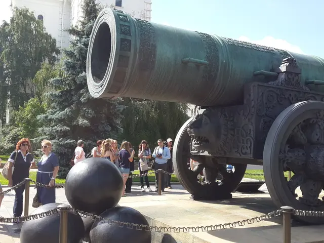 In this picture I can see the cannon weapon. I can see a number of people standing on the surface....