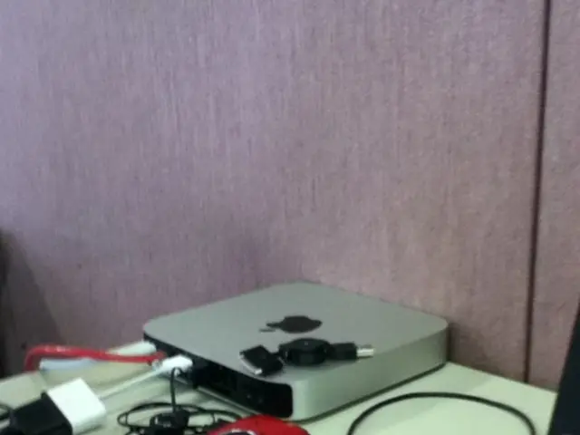 In this picture I can see cables, computer mouses and there are some devices on the table, and in...