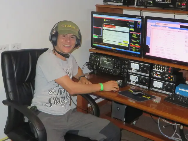 In this picture there is a man who is wearing a grey shirt and is wearing a headphone and a cap on...