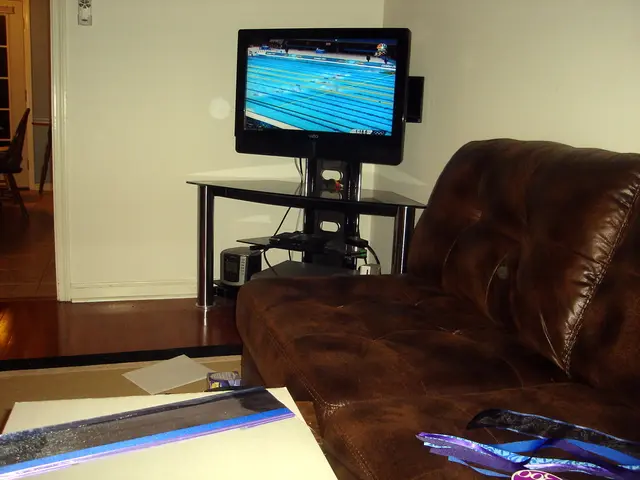 There is a room in the given picture in which a sofa, TV are located. The television is placed on...