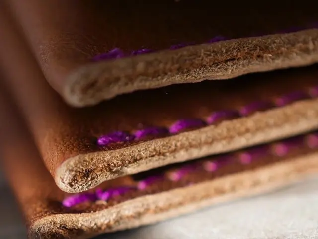 In this image we can see some leather pieces placed on the surface.