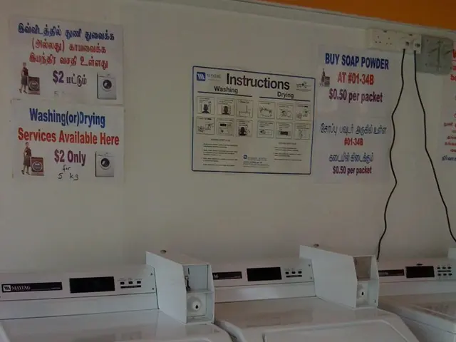 In the center of the image, we can see xerox machines and in the background, there are posters...