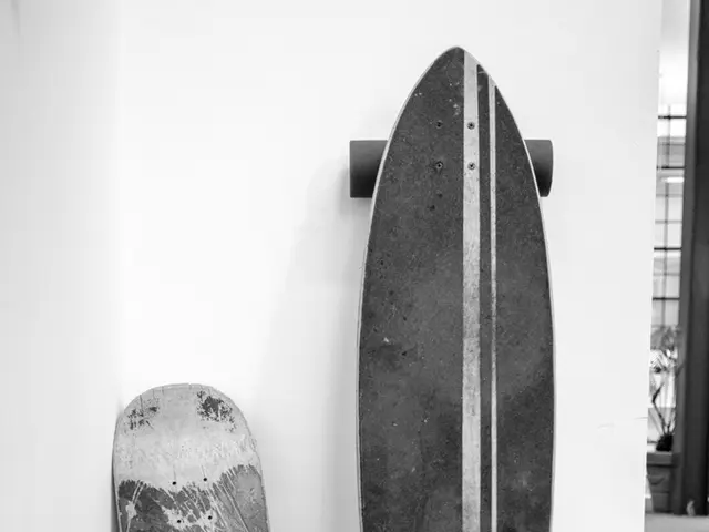 This is a black and white pic. Here we can see a two different types of skateboards on the wall and...
