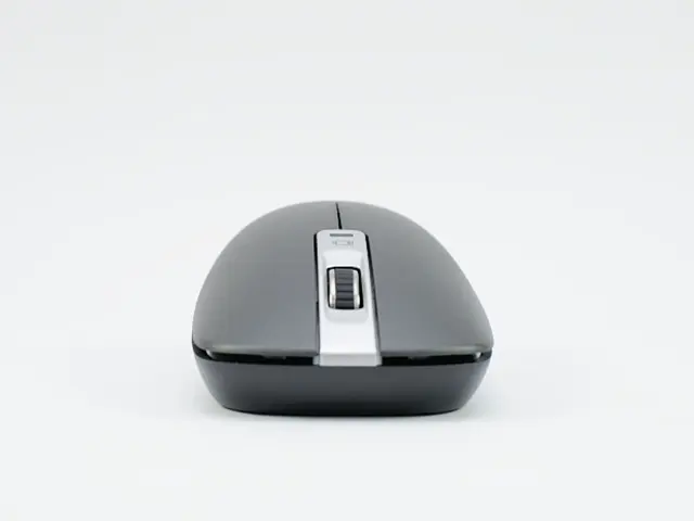 In this picture we can see a wireless mouse here, there is a scroll button here, we can see left...